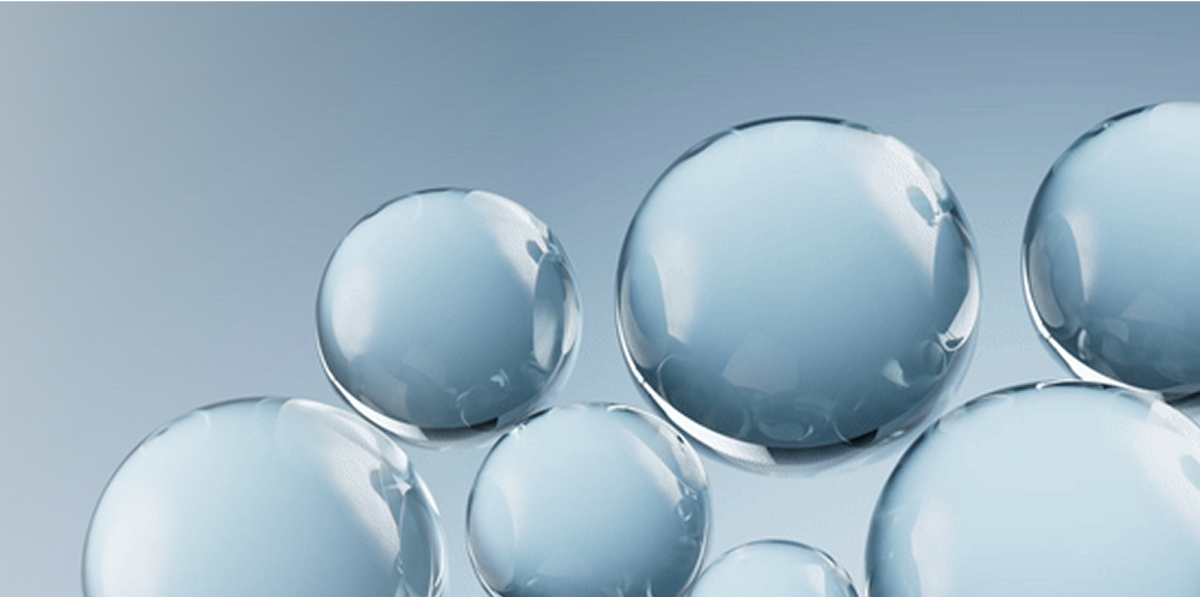 Clear glass marbles on a gray background